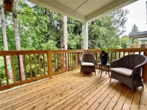 Cedar deck off of kitchen eating area looking on to true greenbelt.