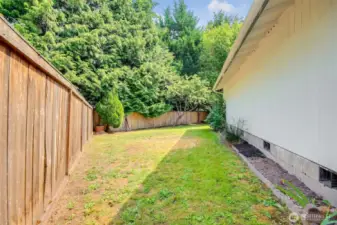 Side of the home fenced in.