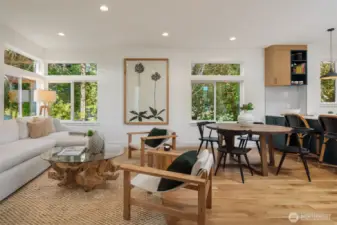 Upstairs, the open-concept main level features soaring 9-foot ceilings, a chef’s kitchen with quartz slab peninsula, locally made Belmont soft-close cabinetry, GE Profile induction range, a rare walk-in pantry, and Delta designer fixtures throughout.