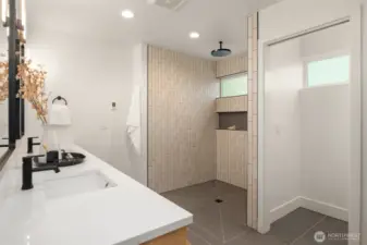 The top-floor primary suite offers Sound views, a walk-in closet, and a spa-like bathroom with a curbless shower and heated floors—even inside the shower!