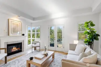 This quality-built townhome features recessed ceilings and a wall of windows. looking out to green space, A Juliette balcony and French Doors are also featured in the living room.