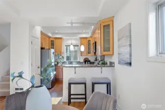 The remodeled kitchen features granite slab counters with an eating bar for two.