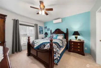 The primary bedroom feels calm and comfortable, with a mini-split system that helps keep the space just right year-round.