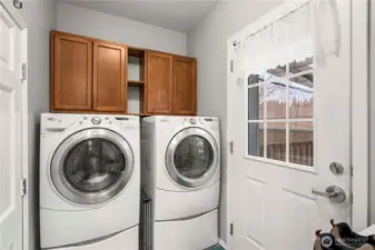 A dedicated laundry area with front-load washer and dryer adds everyday convenience and keeps chores simple.