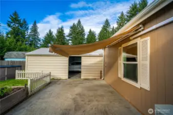 This uncovered patio features a roll-up awning that provides shade and protection, making it easy to enjoy the space year-round.