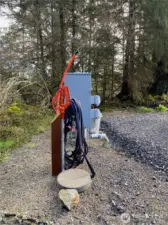 Power and water installed and ready! Shut-off valve under round paver. Fiber ready to be pulled.