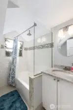 There is a complete bathroom located on the upper floor, featuring a shower that offers a lovely view