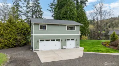 A four-car garage featuring an office suite located on the upper level