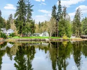 The property boasts a stunning waterfront view, featuring a newly installed bulkhead, a dock that extends over 75 feet, and a convenient boat ramp perfect for launching your kayak or fishing boat
