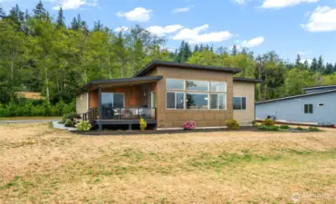 Rear of house that has a deck to open up to the views
