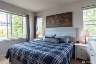 Spacious primary bedroom with room for a king-sized bed, nightstands, and additional furniture. Bright natural light, versatile layout, and a relaxing retreat to call your own.