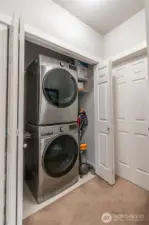 Spacious laundry area with convenient stackable washer and dryer included—designed for efficiency and extra storage. Perfect for modern living, this large utility space makes household chores easier while adding value and functionality to the home.