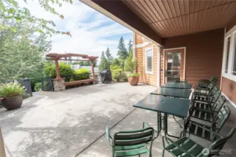 Shared outdoor patio perfect for entertaining, featuring a community grill available by reservation. Enjoy hosting friends, summer barbecues, or relaxing evenings in this inviting space designed for convenience and connection.
