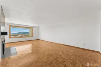 Spacious living room with gas fireplace, and Puget Sound views.