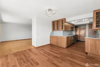 view looking into the dining room, living room, and updated kitchen.