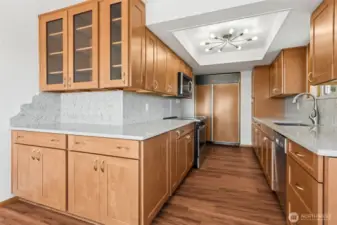 Completely renovated kitchen with quartz countertops, ample storage, and stylish lighting.
