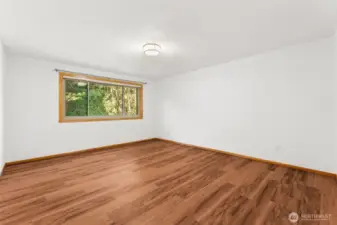 Spacious primary bedroom with private bath and walk-in closet.