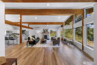High vaulted ceiling with gleaming wood beams - foward towards the rock and wood mantel surrounding the pellet stove.