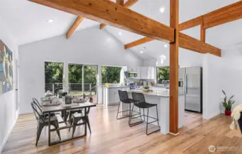 Towards the dining area, island and kitchen. Island accomodates two barstools.