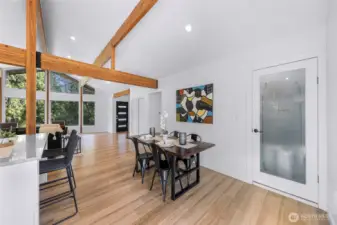 Walk-in pantry is just off of the kitchen and behind the dining area. Hallway in the middle leads to the lower level staircase and the rest of the upper level.