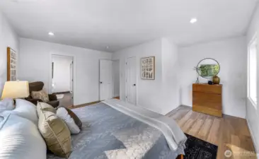 From the corner of the primary bedroom from the left - entry to the primary bath, door to hallway, door to primary closet and then a little alcove space that could be used for a seating area, office, newborn crib space options.