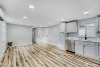 Washer and dryer are in the far corner behind the main entrance door.