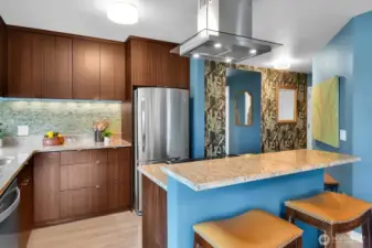 Stainless-steel appliances complement the sleek, European-inspired cabinetry.