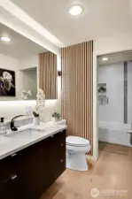 Updated "continental" bath, meaning it's accessible from both the hallway & primary bedroom.