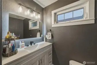 Bathroom updated with new vanity; light fixture, tile floors and fresh paint.