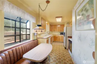 Kitchen with a built in banquet and garden window