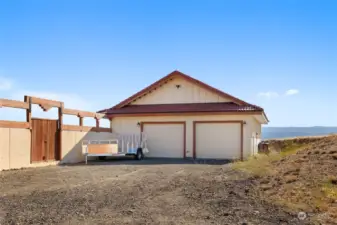 Detached, partially finished 4+ car garage with work benches & storage. Comes with electric car charger.