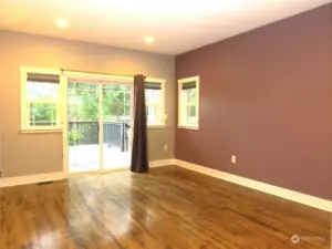 PRIMARY BEDROOM CONTINUES WITH THE HARDWOOD FLOORING AND HAS A PRIVATE ENTRANCE TO THE FULL SIZE DECK!