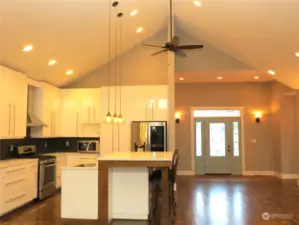 VIEW OF THE GREAT ROOM TOWARD THE KITCHEN SHOWS THE VAULTED CEILINGS AND SLEEK FULL SIZE CABINETS!