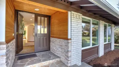 Charming entryway featuring elegant wood accents and brick details, creating a warm and inviting welcome.