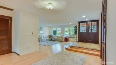 Open-concept layout with a view of the living room adjacent to the entry door, maximizing space and light