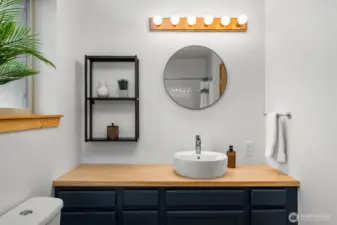 Main level living includes a refreshed full bath with shower and tub adjacent to both bedrooms.
