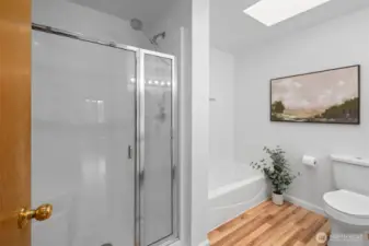Refreshed ensuite 5 piece bath with oversized shower, soaking tub, and skylight.