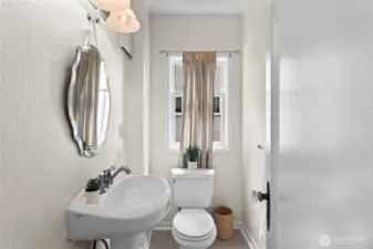 A useful half bath in the hallway between the kitchen and family room