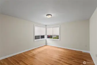 The back bedroom with corner windows and original floors