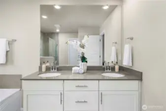 Quartz counter with dual sinks and storage.
