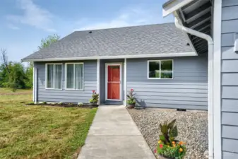 Front walkway with flower beds. Recent Exterior paint on several sides of home. Durable cement planked siding!