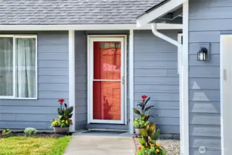 Fresh exterior paint on weather sides of home. Red door with screen compliments the exterior color nicely.