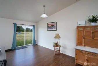 Dining room with slider that opens to backyard.