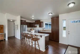 Kitchen with island breakfast bar and seating for three.