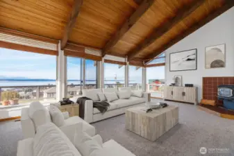 Virtually staged. A row of windows to showcase the views. Whales, eagles, and sailboats - nature on display.