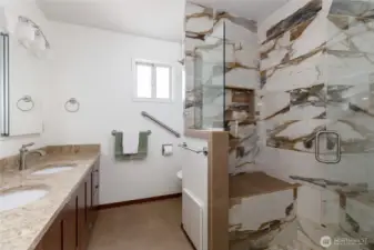Primary bath features a large shower with seat.