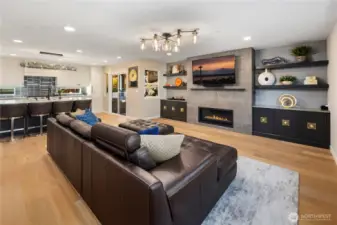 Open space living area with fireplace.