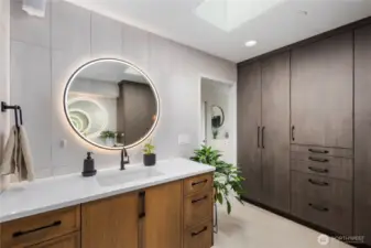 Fully remodeled primary bathroom with heated floors and custom built-in cabinetry