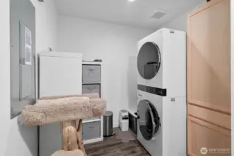 spacious laundry room with additional coat closet just inside from the garage