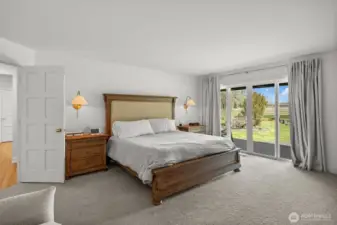 Main floor Primary Suite with double door entry as well as a slider to the deck, with hot tub (buyer to verify working condition).